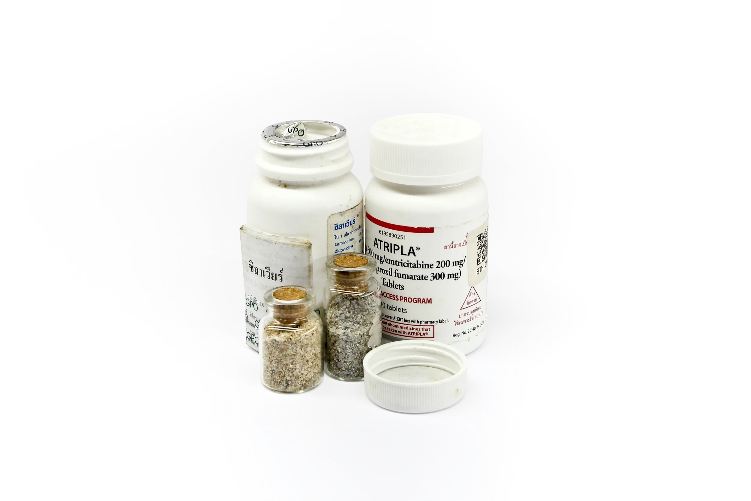 HIV medication bottle and sand